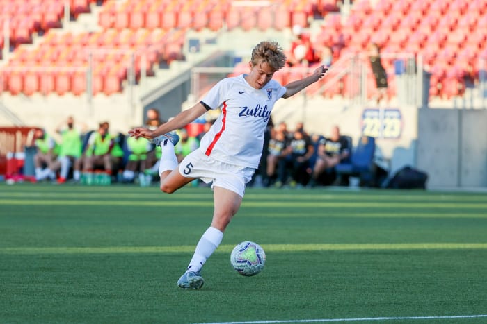 Quinn kicks a soccer ball